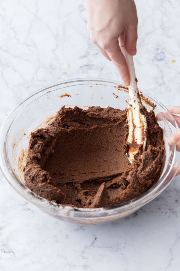 Spreading dough up the side of the bowl so it chills more evenly.