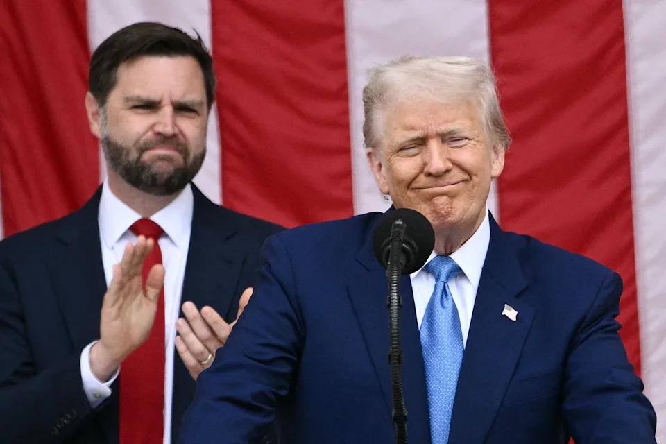 US President Donald Trump delivers remarks as US Vice President JD Vance looks on at the National Memorial Day Observance