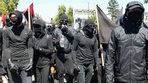 Getty Images Black-clad anti-fascist activists at protests in Berkeley, California