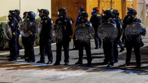 Reuters ICE agents stand guard during a protest against the Trump administration's immigration policies, outside an ICE detention facility in Portland, Oregon, on 01 September, 2025 