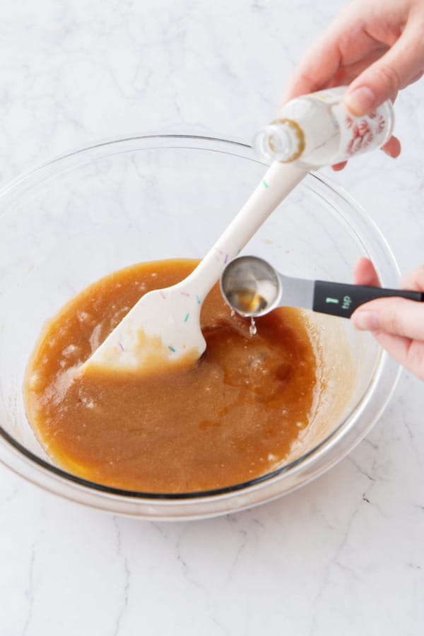 Adding peppermint extract to the batter mixture.