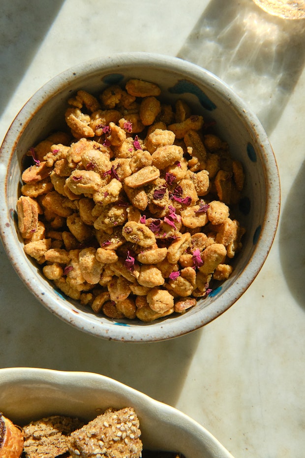 Candied nuts in a small bowl on a marble countertop