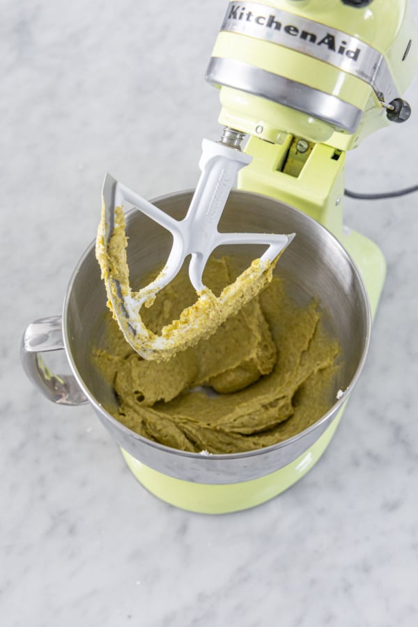 Stand mixer with final frangipane mixture to show consistency on the beater blade.